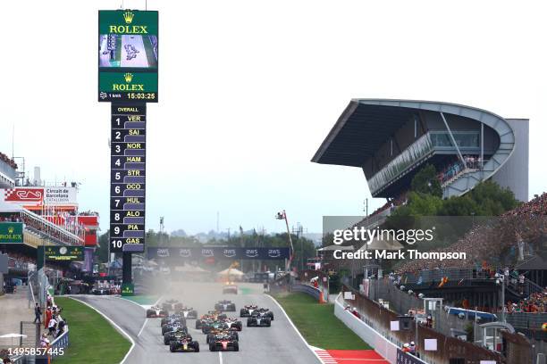 Max Verstappen of the Netherlands driving the Oracle Red Bull Racing RB19 leads Carlos Sainz of Spain driving the Ferrari SF-23 and the rest of the...