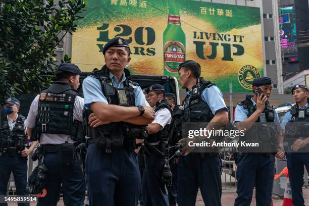 Police officers stand guard at Causeway Bay near Victoria Park on June 04, 2023 in Hong Kong, China. Victoria Park, where Hong Kong traditionally...