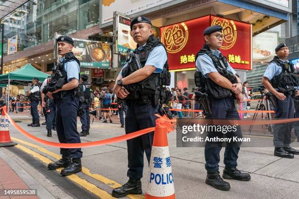 Police officers stand guard at Causeway Bay near Victoria Park on June 04, 2023 in Hong Kong, China. Victoria Park, where Hong Kong traditionally...