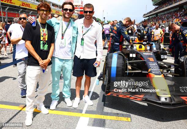 Joao Felix, Ben Chilwell and Mason Mount pose for a photo next to the car of Max Verstappen of the Netherlands and Oracle Red Bull Racing on the grid...