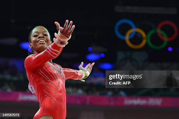 Gymnast Gabrielle Douglas performs on the uneven bars during the women's team final of the artistic gymnastics event of the London Olympic Games on...