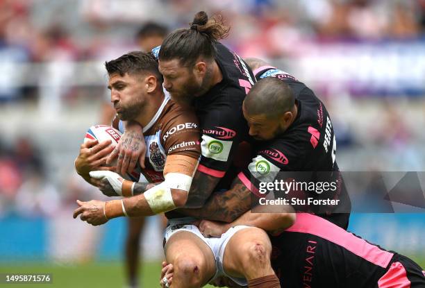 St Helens player Tommy Makinson is wrapped up by the Giants defence during the Betfred Super League Magic Weekend match between St Helens and...