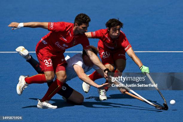 Jacob Draper of Great Britain is tackled by William Ghislain and Tanguy Cosyns of Belgium reacts during the FIH Hockey Pro League Men match between...