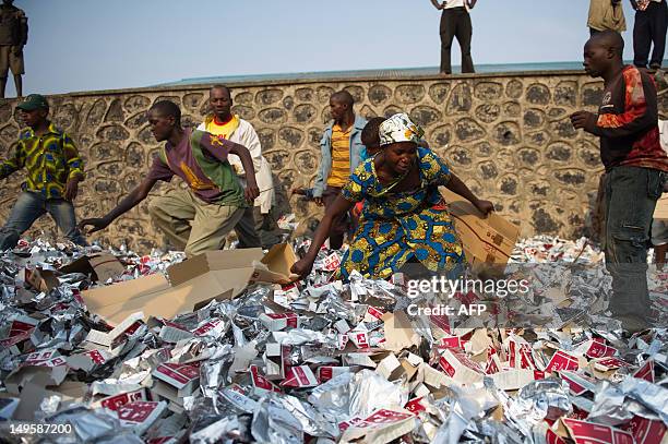 Displaced Congolese people search for food rations in the refuse left from a World Food Programme distribution in Kanyarucinya on the outskirts of...