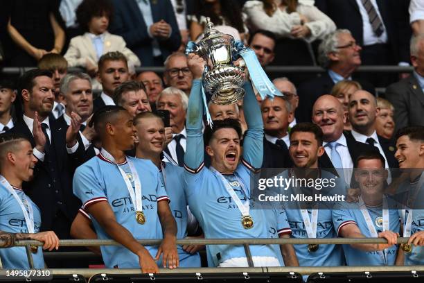 Jack Grealish of Manchester City lifts the trophy at the end of the Emirates FA Cup Final between Manchester City and Manchester United at Wembley...