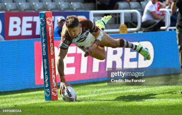 St Helens player Tommy Makinson dives in the corner for his second try during the Betfred Super League Magic Weekend match between St Helens and...