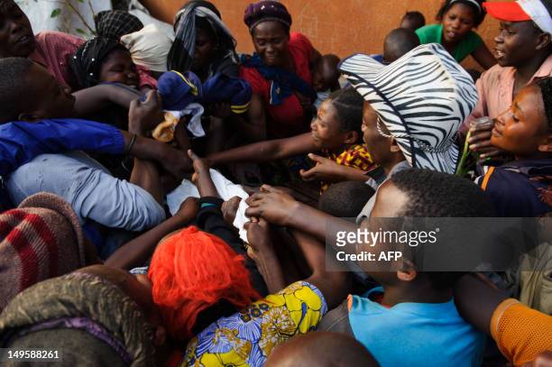 Displaced Congolese scramble for a clothing donation brought by a private individual at a makeshift camp in Kanyarucinya on the outskirts of Goma in...