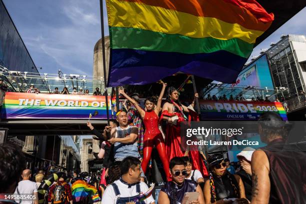 Attendees dance under a giant rainbow flag during a Pride parade on June 04, 2023 in Bangkok, Thailand. Members of the LGBTQ community and allies...