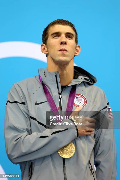 Gold Medallist Michaell Phelps of the United States poses on the podium during the medal ceremony for the Men's 4 x 200m Freestyle Relay final on Day...