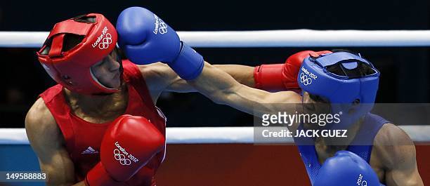 Mohamed Flissi of Alergia defends against Kaeo Pongprayoon of Thailand during their first round Light Flyweight boxing match of the London 2012...