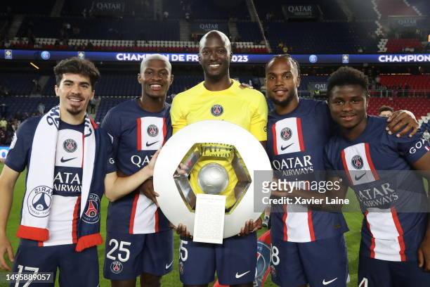 Vitinha, Nuno Mendes, Danilo Pereira, Reanto Sanches and Serif Nhaga of Paris Saint-Germain celebrate the championship trophy after the Ligue 1 match...