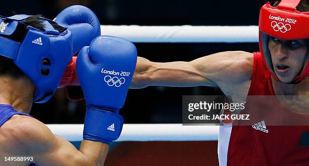 Mohamed Flissi of Alergia defends against Kaeo Pongprayoon of Thailand during their first round Light Flyweight boxing match of the London 2012...