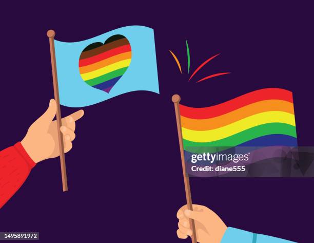hands holding pride flags - pride flag stock illustrations