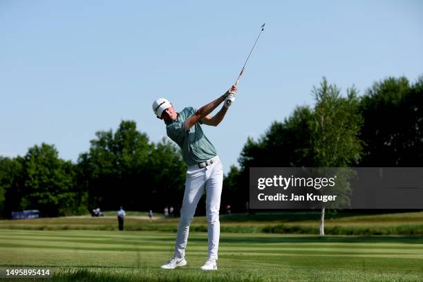 Tom McKibbin of Northern Ireland plays his second shot on the 18th hole on Day Four of the Porsche European Open at Green Eagle Golf Course on June...