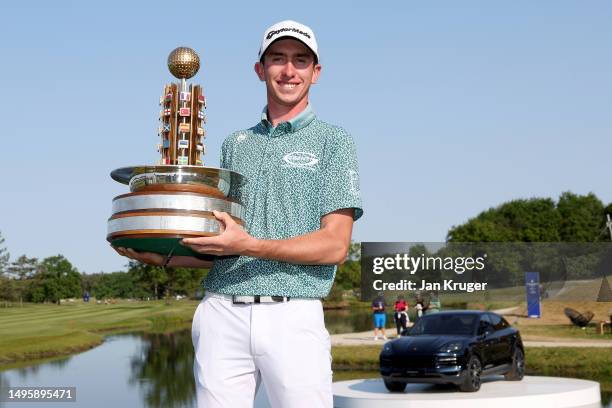 Tom McKibbin of Northern Ireland poses with the trophy after winning the Porsche European Open on the 18th hole on Day Four of the Porsche European...