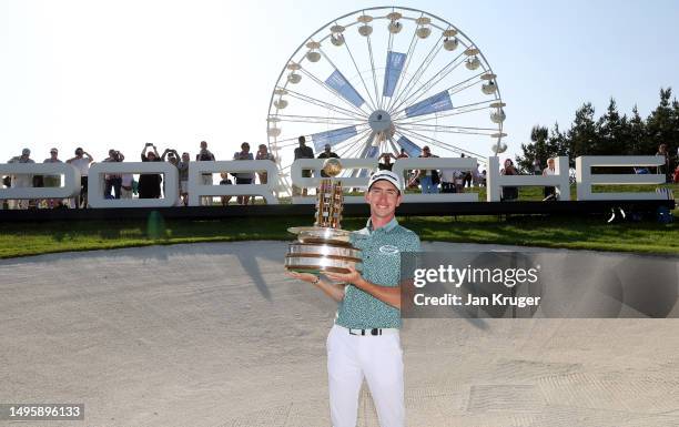Tom McKibbin of Northern Ireland poses with the trophy after winning the Porsche European Open on the 18th hole on Day Four of the Porsche European...