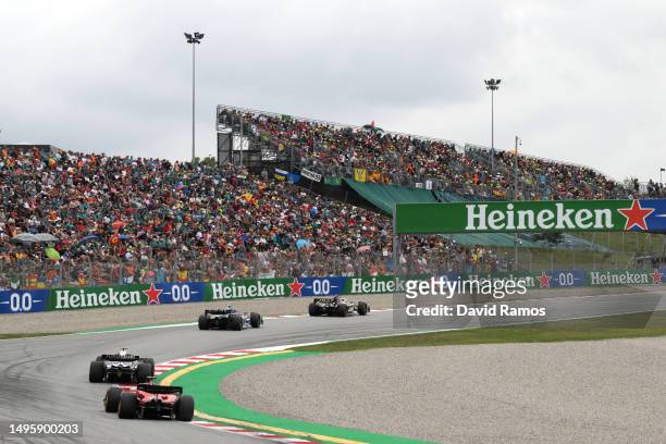Kevin Magnussen of Denmark driving the Haas F1 VF-23 Ferrari leads Pierre Gasly of France driving the Alpine F1 A523 Renault, Nyck de Vries of...