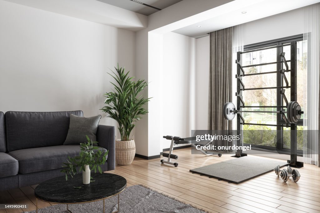 Sala de estar interior con sofá, mesa de centro, barra y mancuernas. Entrenamiento en casa con material deportivo
