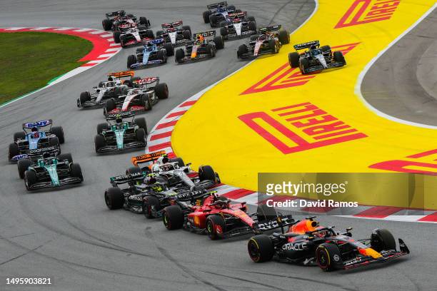 Max Verstappen of the Netherlands driving the Oracle Red Bull Racing RB19 leads Carlos Sainz of Spain driving the Ferrari SF-23 and the rest of the...