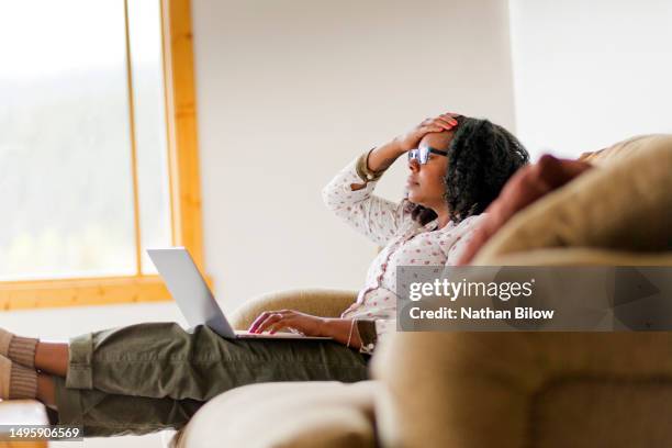 african-american woman works from her computer - woman in shower tattoo stock pictures, royalty-free photos & images