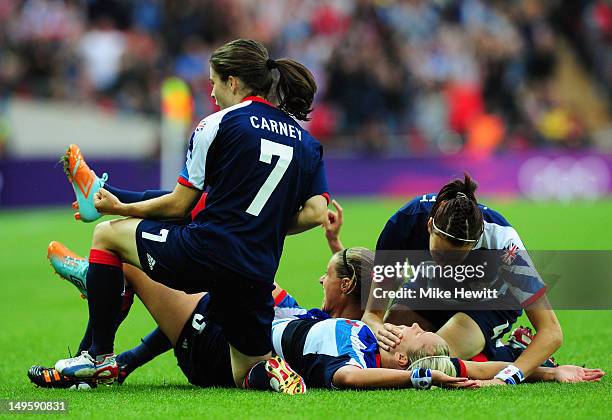 Stephanie Houghton of Great Britain celebrates with her team-mates after scoring the opening goal during the Women's Football first round Group E...