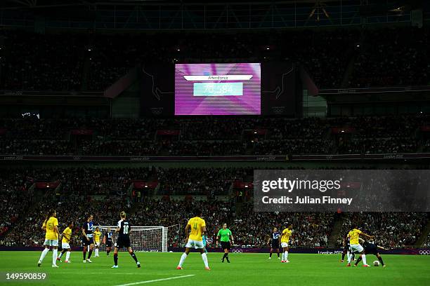 The big screen in the stadium displays the attendance at the match as 70,584 during the Women's Football first round Group E Match between Great...