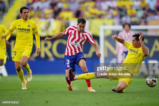 Sergio Reguilon of Atletico Madrid is challenged by Aissa Mandi of Villarreal CF during the LaLiga Santander match between Villarreal CF and Atletico...