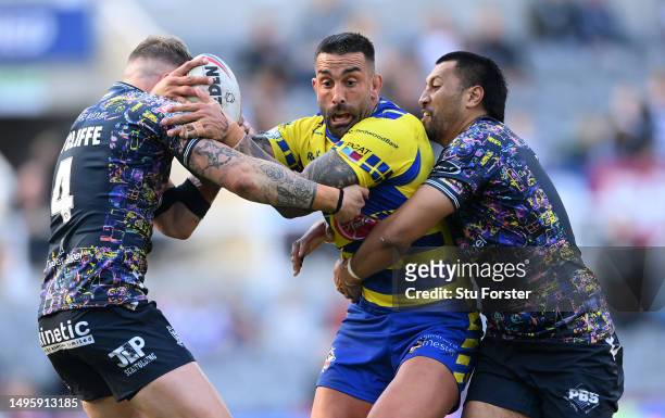 Warrington player Paul Vaughan is wrapped up by the Hull FC defence during the Betfred Super League Magic Weekend match between Hull FC and...