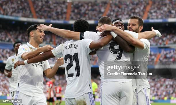 Karim Benzema of Real Madrid celebrates with teammates after scoring the team's first goal from a penalty kick during the LaLiga Santander match...