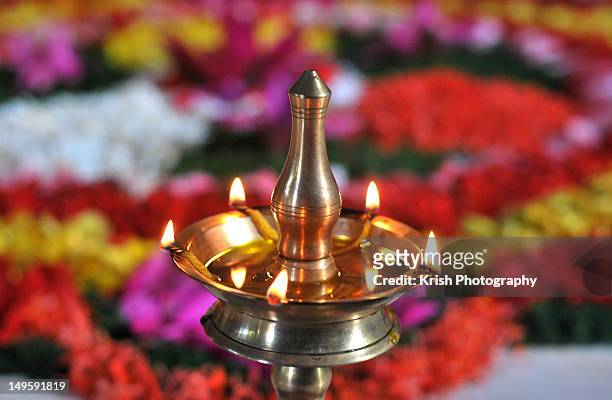 oil lamp and floral arrangement. - onam stock pictures, royalty-free photos & images