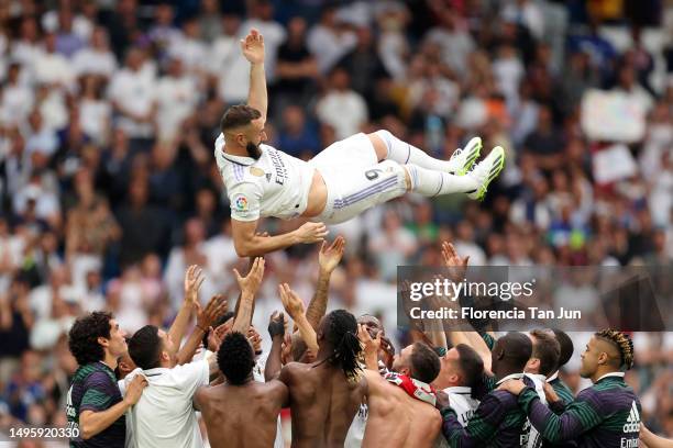 Karim Benzema of Real Madrid is thrown in the air by teammates following the LaLiga Santander match between Real Madrid CF and Athletic Club at...