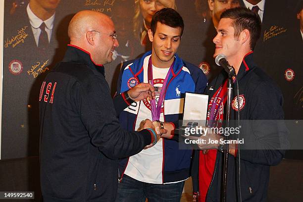 Olympians Nick McCrory and David Boudia present their coach Drew Johansen with the Order of Ikkos medal at the USA House at the Royal College of Art...