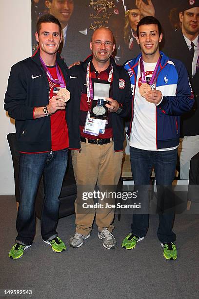 Olympians Nick McCrory and David Boudia present their coach Drew Johansen with the Order of Ikkos medal at the USA House at the Royal College of Art...