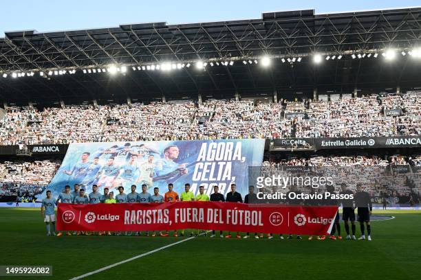 Both teams and officials stand in solidarity displaying a banner stating no to racism prior to the LaLiga Santander match between RC Celta and FC...