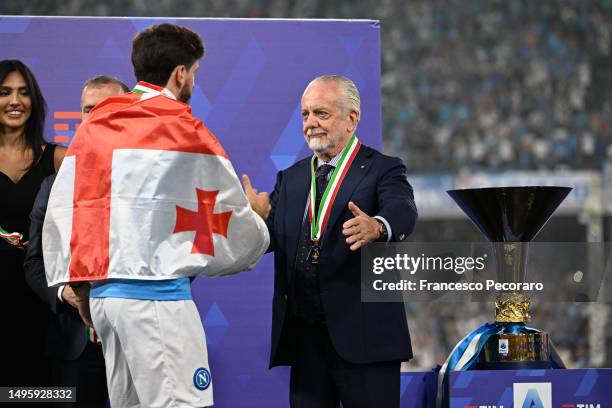 President of SSC Napoli, Aurelio De Laurentiis, shakes hands with Khvicha Kvaratskhelia of SSC Napoli next to the Serie A trophy following the Serie...