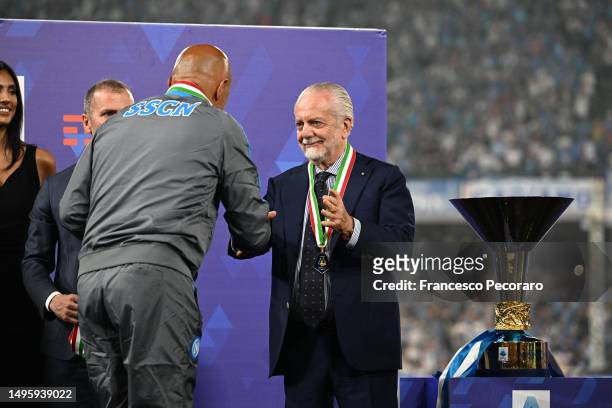 President of SSC Napoli, Aurelio De Laurentiis, shakes hands with Luciano Spalletti, Head Coach of SSC Napoli, next to the Serie A trophy following...