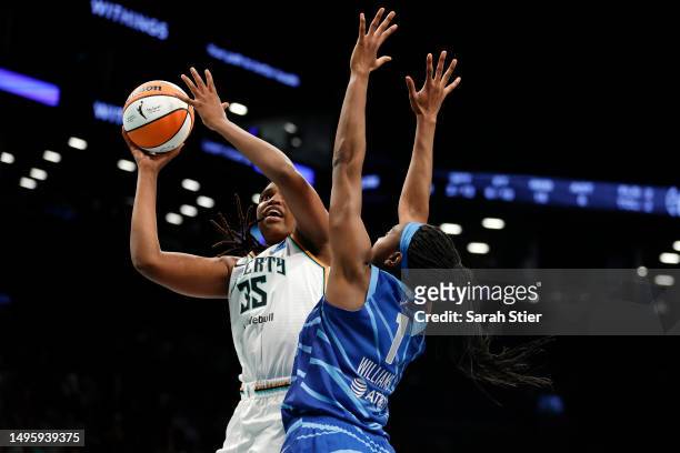 Jonquel Jones of the New York Liberty goes to the basket as Elizabeth Williams of the Chicago Sky defends during the first half at Barclays Center on...