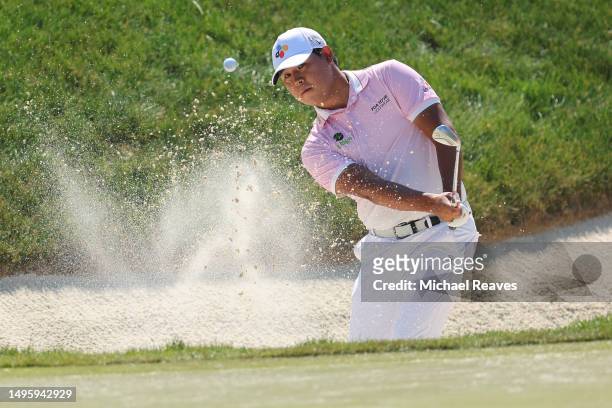 Si Woo Kim of South Korea plays a shot from a bunker on the tenth hole during the final round of the Memorial Tournament presented by Workday at...