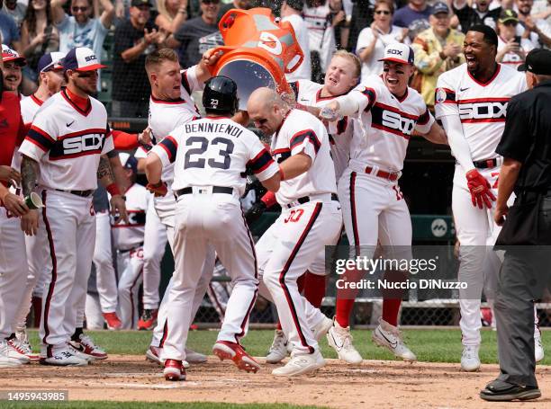 Jake Burger of the Chicago White Sox is mobbed by teammates following a walk off grand slam during the ninth inning of a game against the Detroit...