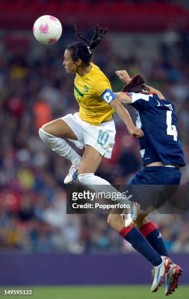 Marta of Brazil heads the ball while challenged by Jill Scott of Great Britain during the Women's Football first round Group E Match between Great...