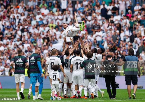 Karim Benzema of Real Madrid is lfted into the air by teammates at the end during the LaLiga Santander match between Real Madrid CF and Athletic Club...