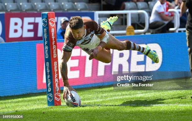 St Helens player Tommy Makinson dives in the corner for his second try during the Betfred Super League Magic Weekend match between St Helens and...