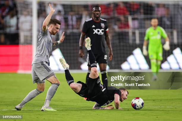 Lewis O'Brien of D.C. United is upended by Joel Waterman of CF Montréal during the first half of the MLS game at Audi Field on May 31, 2023 in...