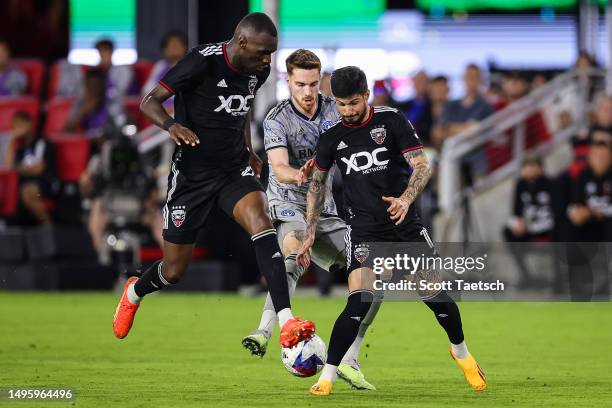 Joel Waterman of CF Montréal competes with the ball against Christian Benteke and Taxiarchis Fountas of D.C. United during the second half of the MLS...