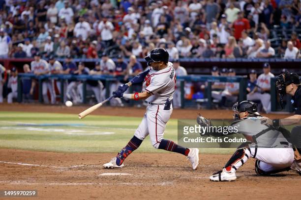 Eddie Rosario of the Atlanta Braves hits a grand slam against the Arizona Diamondbacks during the ninth inning at Chase Field on June 04, 2023 in...
