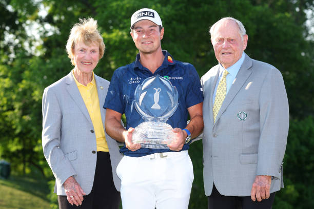 Viktor Hovland of Norway poses with the trophy and `1and his wife Barbara Nicklaus after winning the Memorial Tournament presented by Workday at...