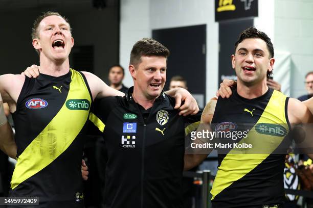 Jack Riewoldt of the Tigers, Tigers interim head coach Andrew McQualter and Tim Taranto of the Tigers sing the team song as they celebrate victory...