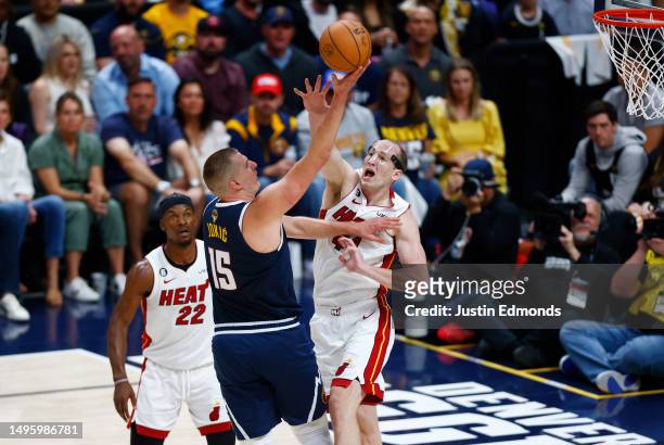 Nikola Jokic of the Denver Nuggets drives to the basket against Cody Zeller of the Miami Heat during the first quarter in Game Two of the 2023 NBA...