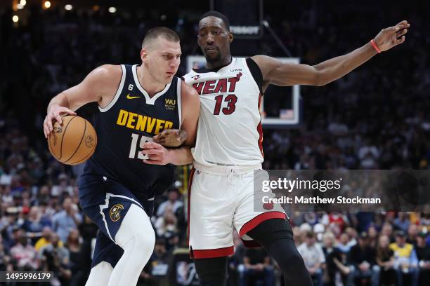 Nikola Jokic of the Denver Nuggets dribbles against Bam Adebayo of the Miami Heat during the third quarter in Game Two of the 2023 NBA Finals at Ball...