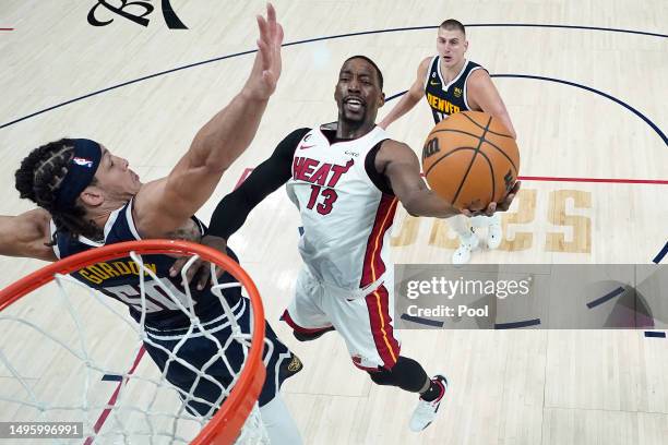 Bam Adebayo of the Miami Heat drives to the basket against Aaron Gordon of the Denver Nuggets during the second half in Game Two of the 2023 NBA...
